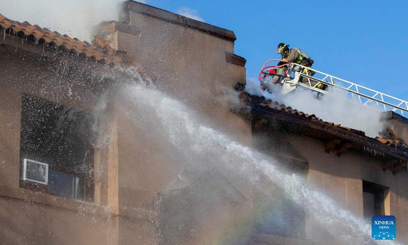 A firefighter works to extinguish a fire burning at an apartment building in Toronto, Canada, on Jan. 15, 2022.Photo:Xinhua