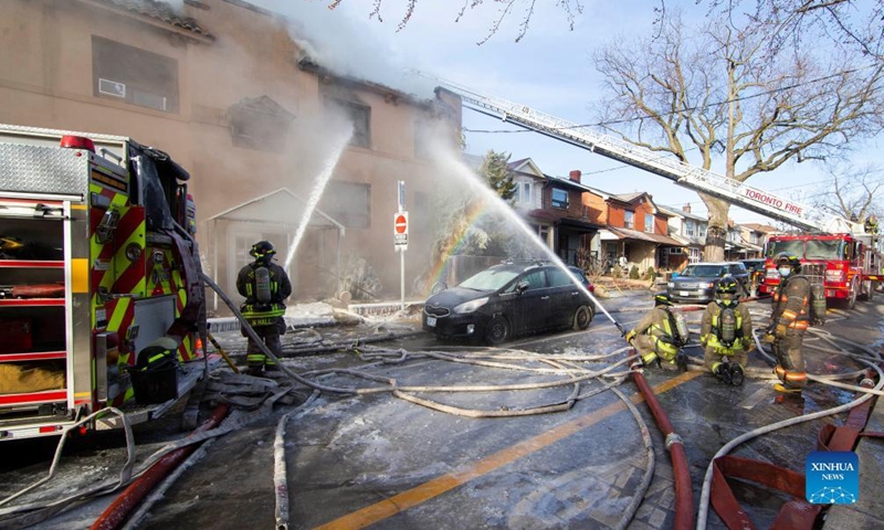 Firefighters work to extinguish a fire burning at an apartment building in Toronto, Canada, on Jan. 15, 2022.Photo:Xinhua