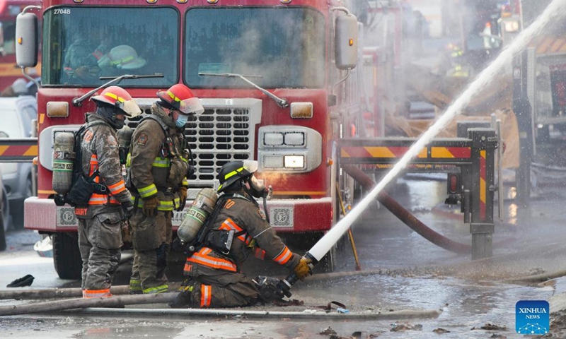 Firefighters work to extinguish a fire burning at an apartment building in Toronto, Canada, on Jan. 15, 2022.Photo:Xinhua
