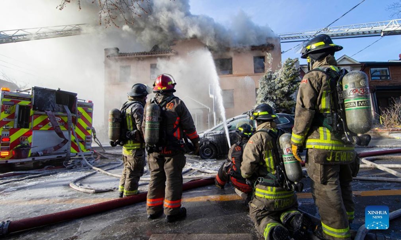 Firefighters work to extinguish a fire burning at an apartment building in Toronto, Canada, on Jan. 15, 2022.Photo:Xinhua